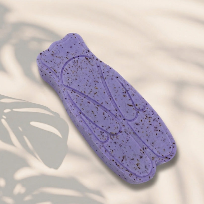 Savon en forme de cigale au parfum de lavande, agrémenté de fleurs exfoliantes.